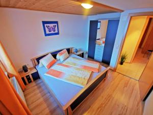a bedroom with a blue bed and a wooden floor at Appartment Elias in Bichl
