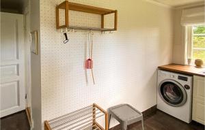 a laundry room with a washing machine and a washer at Awesome Home In Trans With Kitchen in Tranås