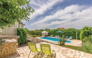 a patio with chairs and a swimming pool at Awesome Home In Vinjani Donji With 4 Bedrooms, Wifi And Outdoor Swimming Pool in Crna Gora