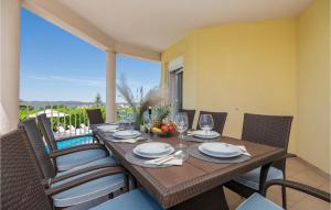 a dining room table with chairs and a tableasteryasteryasteryasteryasteryasteryastery at Awesome Home In Vinjani Donji With 4 Bedrooms, Wifi And Outdoor Swimming Pool in Crna Gora