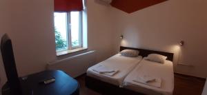 a small room with two beds and a window at HappyRooms Piata Romana in Bucharest