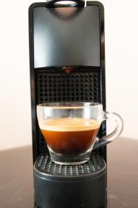a cup of coffee in a coffee maker at Little Gem Hotel Tulum La Veleta in Tulum