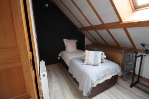 a bedroom with two beds with white sheets at gite des 3 rivières in Longeault