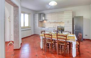 y cocina con mesa, sillas y nevera. en Nice Home In Fucecchio With Outdoor Swimming Pool, en Fucecchio