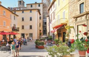 a group of people walking down a street with buildings at Casa La Montesca in Città di Castello