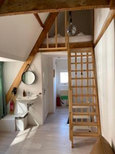 a room with a loft bed and a sink at Tiny Private City Rooms Haarlem in Haarlem