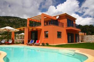a house with a swimming pool in front of a house at Villa Brio Exclusive in Skala