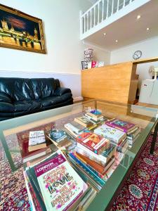 a glass table with books on it in a living room at Melbourne House Hotel in London