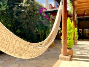 a hammock hanging from a pole in a garden at Hotel Casa Azabache in San Cristóbal de Las Casas