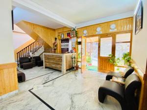 a living room with wooden walls and a staircase at Sai Cottage Shimla in Shimla