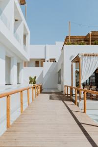 a wooden walkway leading to a building at Abonora Drymades in Dhërmi