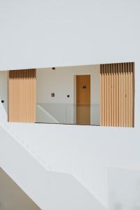 a view of a hallway with two doors and a mirror at Abonora Drymades in Dhërmi
