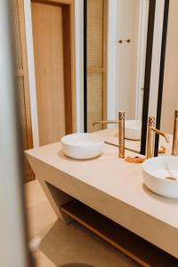 a bathroom with two sinks and a mirror at Abonora Drymades in Dhërmi