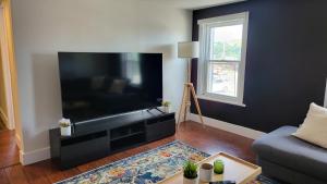 a living room with a large flat screen tv at JstLikeHome - Old Ottawa in Ottawa