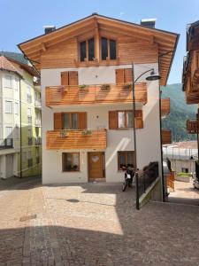 a building with a motorcycle parked in front of it at Casa dei Tabachi in Molveno