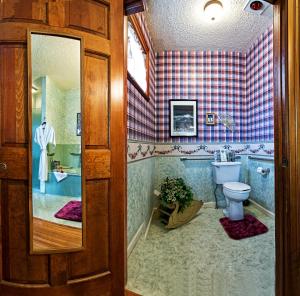 a bathroom with a tub and a toilet and a sink at Holden House 1902 Bed & Breakfast Inn in Colorado Springs