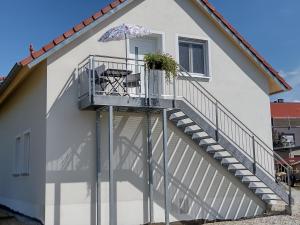 a house with a staircase with an umbrella at Ferienwohnung Regina in Berching