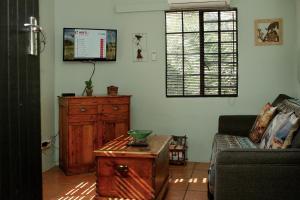 a living room with a couch and a table at The Green Lantern - Howick in Howick