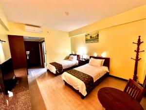 Postel nebo postele na pokoji v ubytování Serenti Hotel Saipan