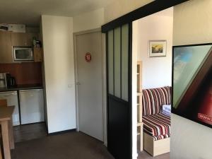 sala de estar con puerta corredera y TV en Appartement aux pieds des pistes la tania courchevel, en La Perrière