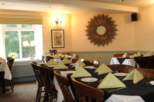 a dining room with tables and chairs and a mirror at Queens arms country inn in Glossop