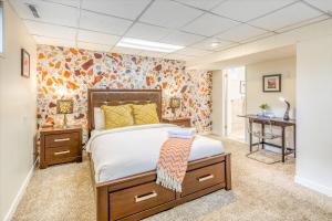 a bedroom with a bed and a floral wall at Luxury Home By North Glenmore Park in Calgary
