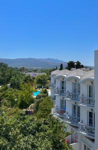 ariale Aussicht auf ein Gebäude mit Pool und Bäumen in der Unterkunft Theodorou Beach Hotel Apartments in Kos-Stadt