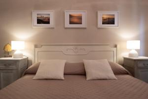 a bedroom with a white bed with two night stands and two lamps at Costa Bed and Breakfast in Pollutri