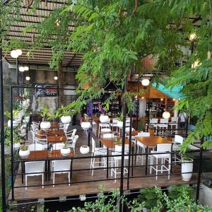 um restaurante com mesas de madeira e cadeiras brancas em La place em Mactan