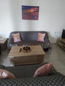 a living room with a couch and a coffee table at Aegean View Seaside Apartment in Kavála