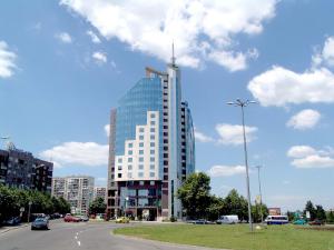 a tall glass building with a antenna on top of it at Mirage Hotel in Burgas
