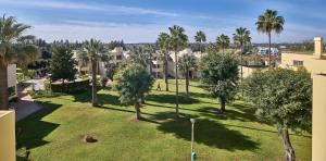 an aerial view of a park with palm trees and buildings at Parque Mourabel, Oásis Village & Pé do Lago in Vilamoura