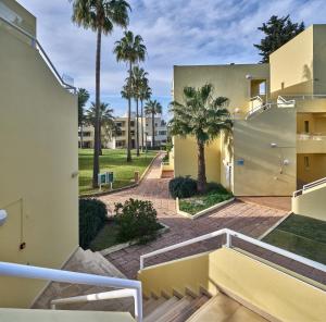 a view from the balcony of a house with palm trees at Parque Mourabel, Oásis Village & Pé do Lago in Vilamoura