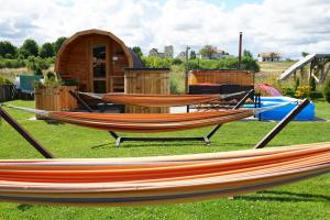 a couple of hammocks sitting on the grass at Resort Mielenko in Mielenko