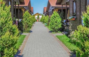 a walkway between houses with christmas trees at Stunning Home In Wicie With 2 Bedrooms in Wicie
