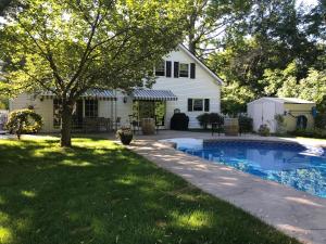 a backyard with a pool and a house at Upper Canada Coach House in Niagara-on-the-Lake