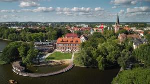an aerial view of a city with a river and a church at Loft Barnim w wieży strażackiej, 2-poziomowy, 100m2, taras na dachu in Szczecinek