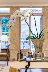 a vase filled with white flowers on a table at Relais & Châteaux Hotel Orfila in Madrid