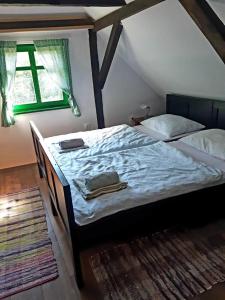 a large bed in a room with a window at Bakina iža in Duga Resa