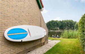 a surfboard on the side of a brick building at 3 Bedroom Cozy Home In Vlagtwedde in Vlagtwedde