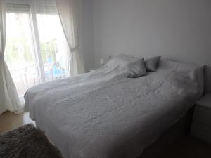 a white bed in a bedroom with a window at Linnea Sol Blanca in Villamartin +31 photos