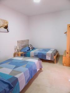 A bed or beds in a room at Chalet amplio con Jardín y zona barbacoa.