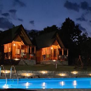 a house at night with a pool in front of it at Imperator Kvintil apartmani & SPA in Ležimir