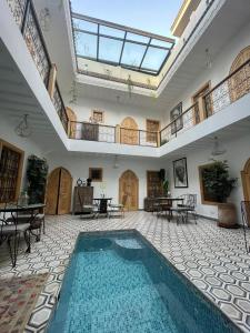 an indoor swimming pool in a large room with a ceiling at Riad Le Petit Joyau in Marrakech