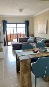 a living room with a couch and a table at Balcon del Mar A&V Ocen View Costa del Silencio in Costa Del Silencio