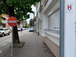 a do not enter sign on a sidewalk next to a building at Anja Apartman in Bosanski Šamac