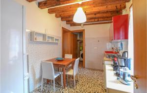 a kitchen with a wooden table and chairs in a room at Lovely Apartment In Venezia With Wifi in Venice +17 photos