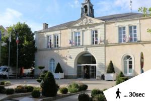 a building with a person walking in front of it at Au coucher de soleil - Dormir comme à la maison - in Châteaubriant