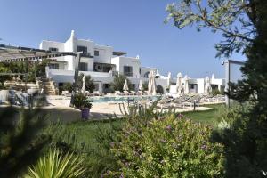 a view of a resort with a pool and chairs at Naoussa Hills Boutique Resort- Adults Only (13+) in Naousa