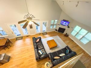 an overhead view of a living room with a couch and a tv at Peaceful treetop escape! Pool table, grill, games, sleeps 10! in Helen